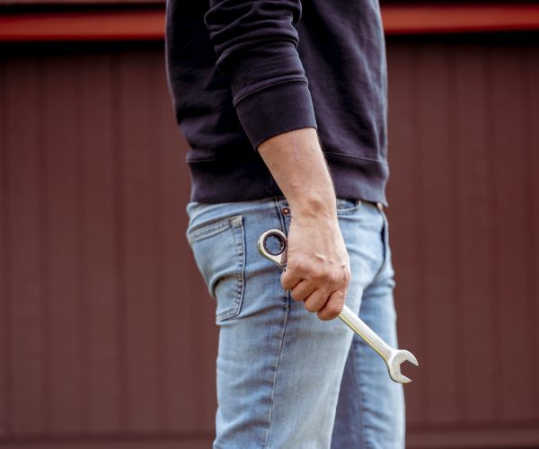 A closeup shot of a technician holding a tool
